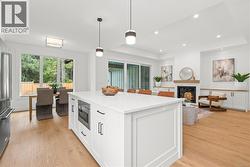 The well designed kitchen features roll out cabinet above the fridge and beside the stove as well as rollers in the pantry cabinet -