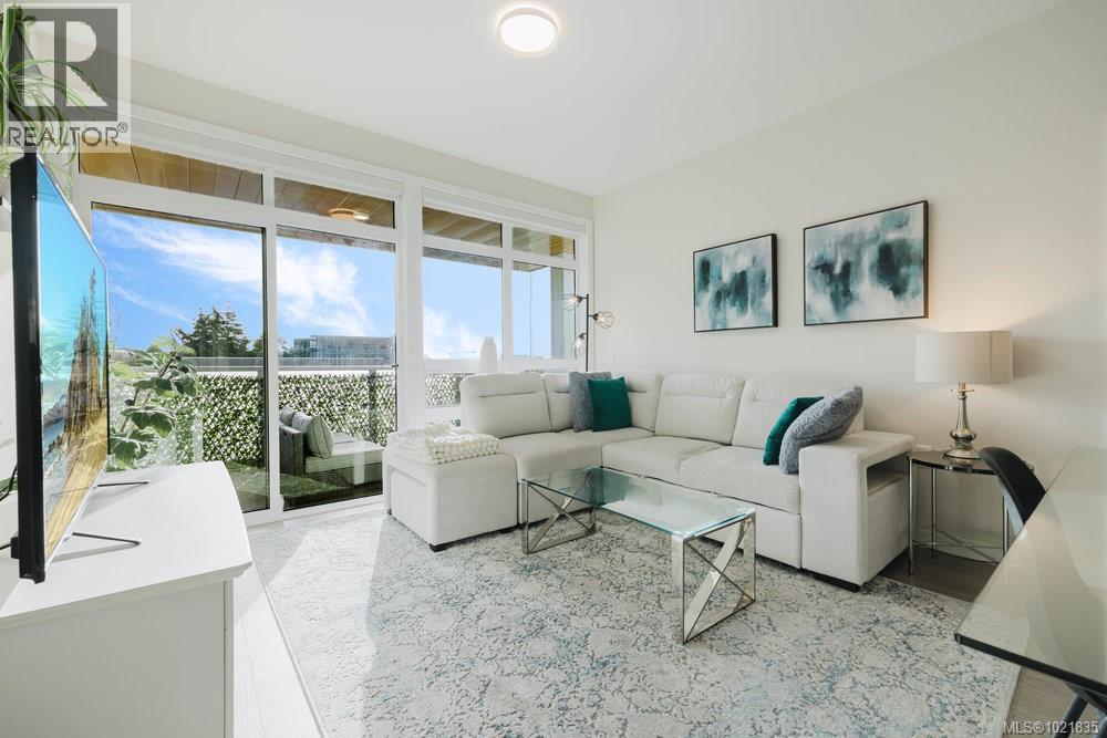 View of living area and balcony - 210 881 Short St, Saanich, BC - Indoor Photo Showing Living Room