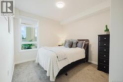 Carpeted bedroom with baseboards -