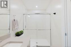 Bathroom with vanity and a stall shower -
