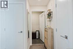 Hall featuring dark wood finished floors -