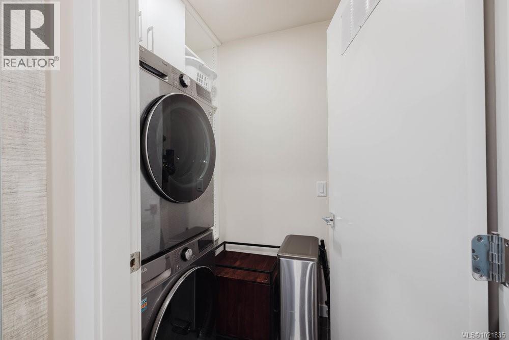 Laundry area with stacked washer / drying machine - 210 881 Short St, Saanich, BC - Indoor Photo Showing Laundry Room