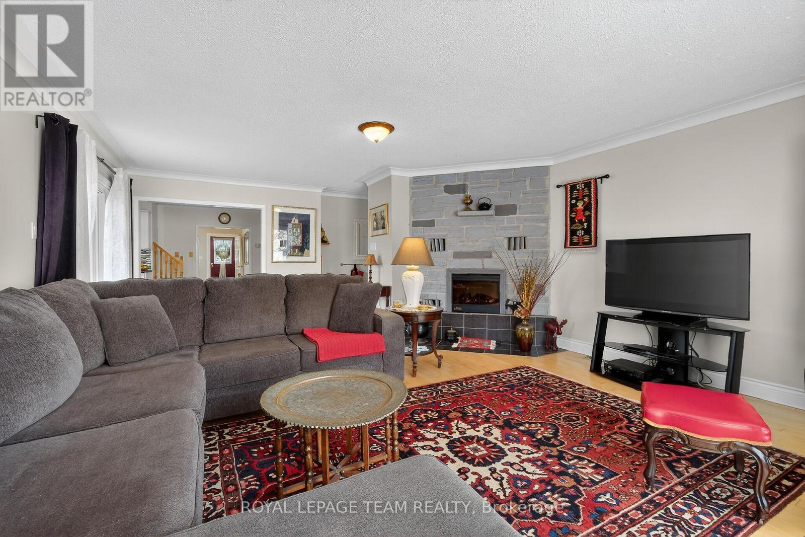 Stone electric fireplace - 97 Woodward Street, Carleton Place, ON - Indoor Photo Showing Living Room With Fireplace