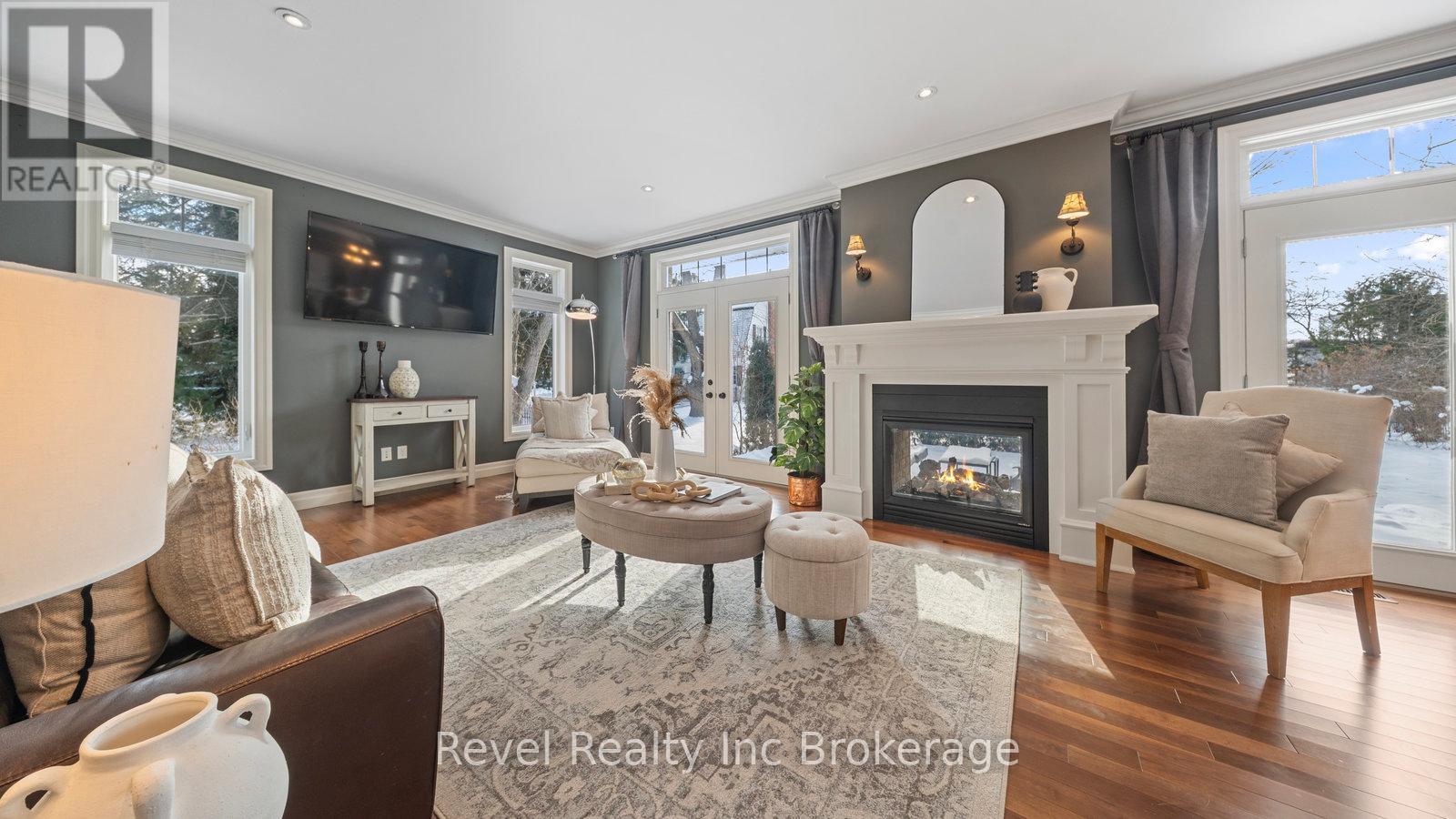 Living Room with 2-way Fireplace - 624 Devonshire Avenue, Woodstock (Woodstock - North), ON - Indoor Photo Showing Living Room With Fireplace