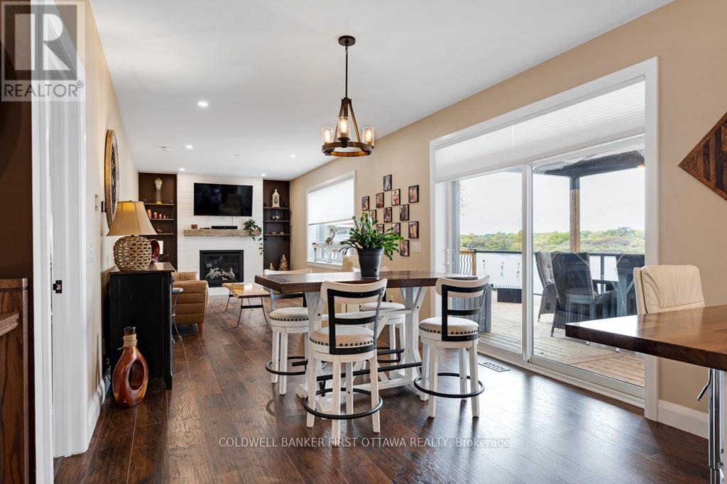 Light-filled with quality laminate plank flooring - 38 Tuttle Point Road, Edwardsburgh/Cardinal, ON - Indoor Photo Showing Dining Room