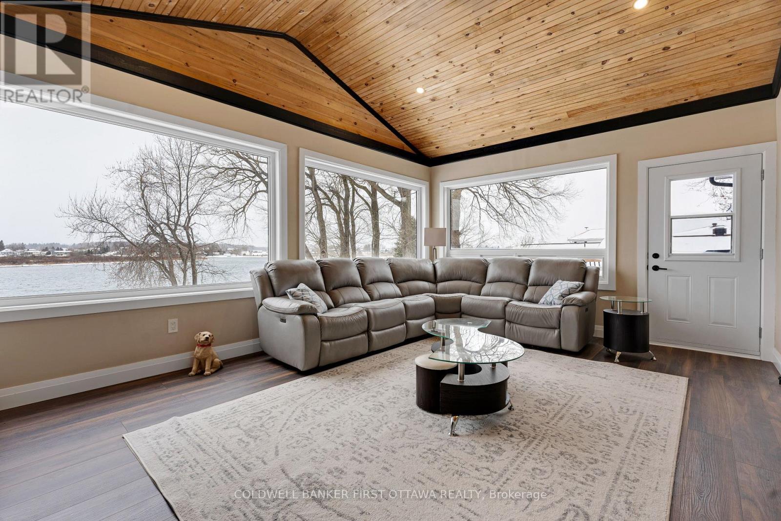 Wrap about windows for never ending river views - 38 Tuttle Point Road, Edwardsburgh/Cardinal, ON - Indoor Photo Showing Living Room