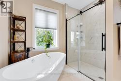 Ensuite large soaker tub & rainhead glass shower -