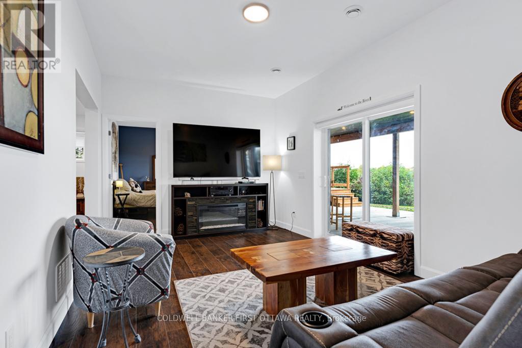 Lower level family room, walkout to patio - 38 Tuttle Point Road, Edwardsburgh/Cardinal, ON - Indoor Photo Showing Living Room