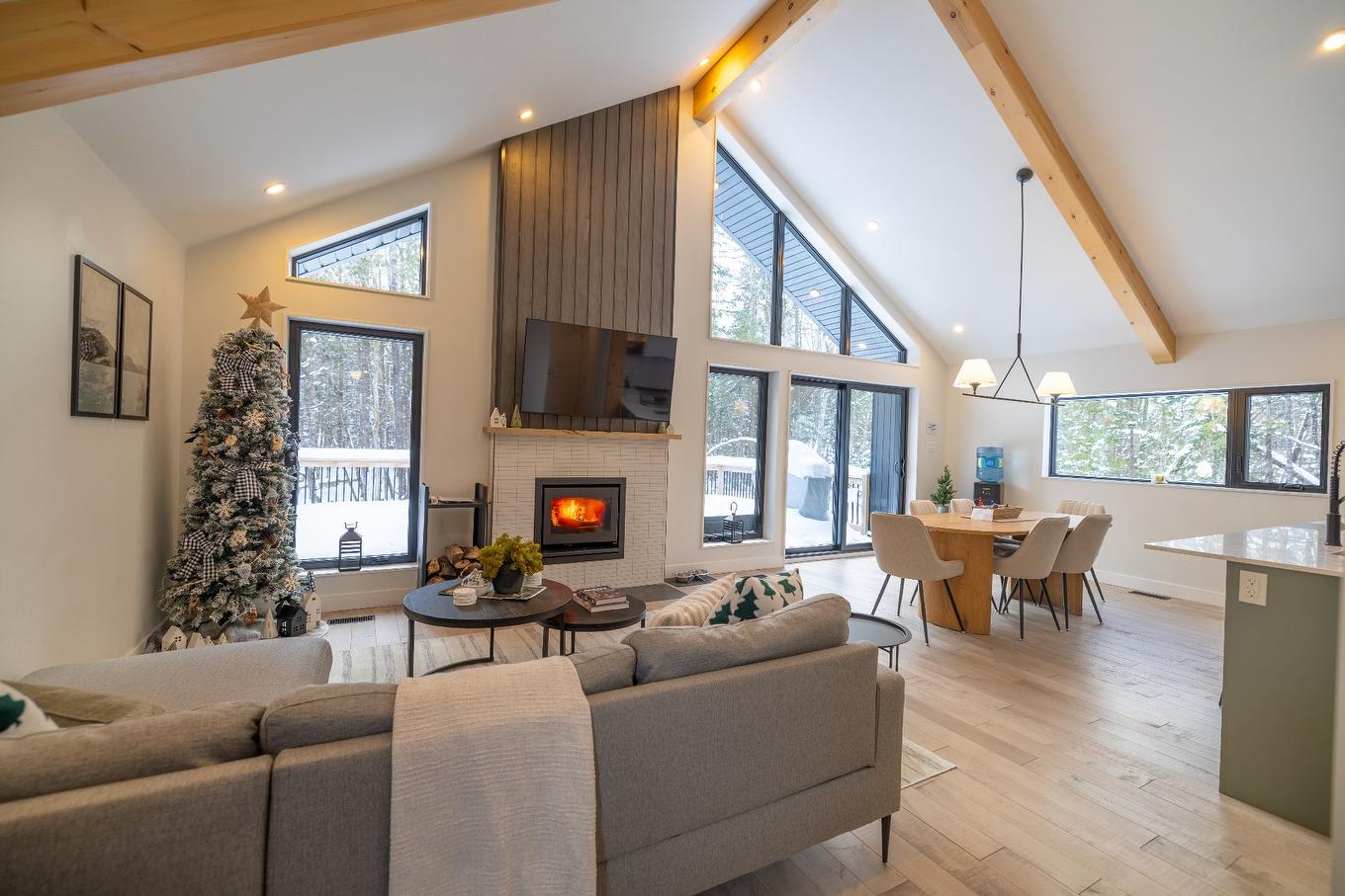 Aerial photo - 215 Ch. Des Chênes, Amherst, QC - Indoor Photo Showing Living Room With Fireplace