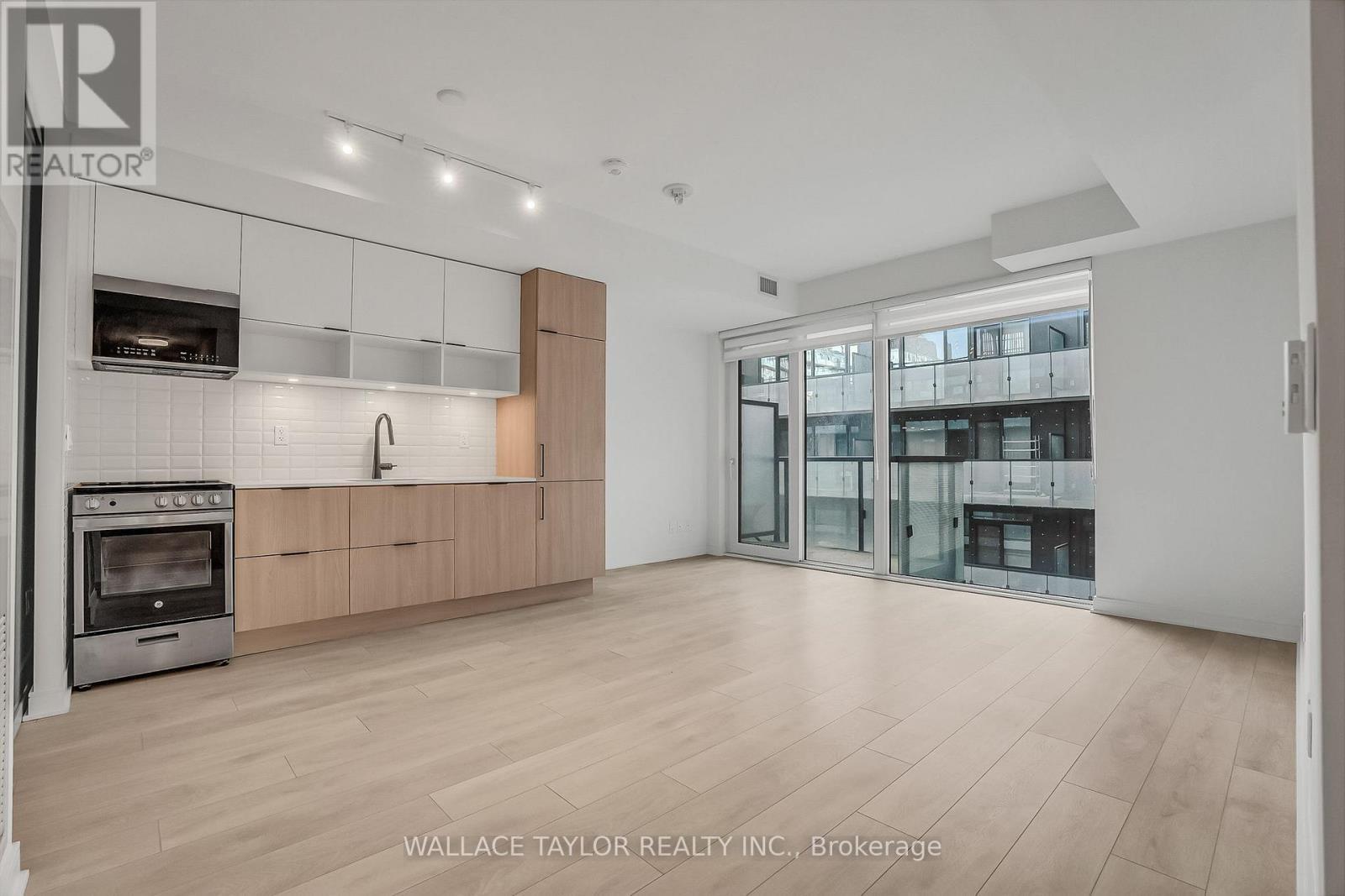 Kitchen / Living / Dining - 12 - 35 Rolling Mills Road, Toronto, ON - Indoor Photo Showing Kitchen With Fireplace
