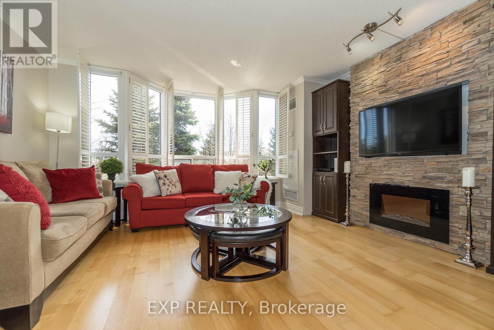 220 - 80 Harrison Garden Boulevard, Toronto, ON - Indoor Photo Showing Living Room With Fireplace