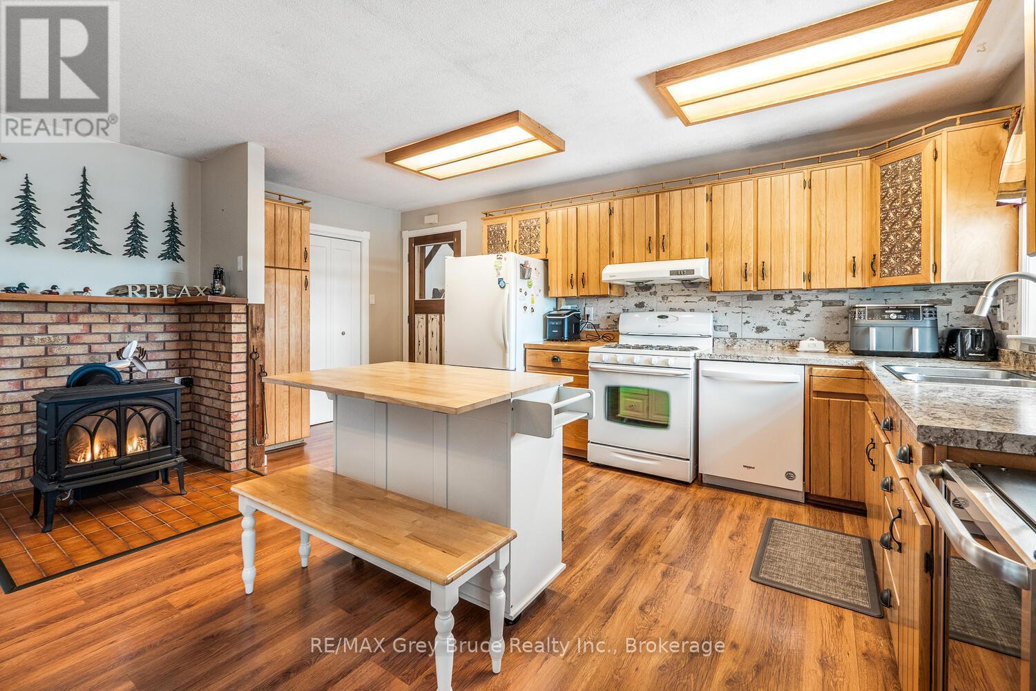 109 Widgeon Cove Road, Northern Bruce Peninsula, ON - Indoor Photo Showing Kitchen With Fireplace With Double Sink