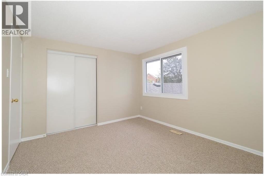 Unfurnished bedroom with a closet and carpet - 455 Kingscourt Drive Unit# 3, Waterloo, ON - Indoor Photo Showing Other Room