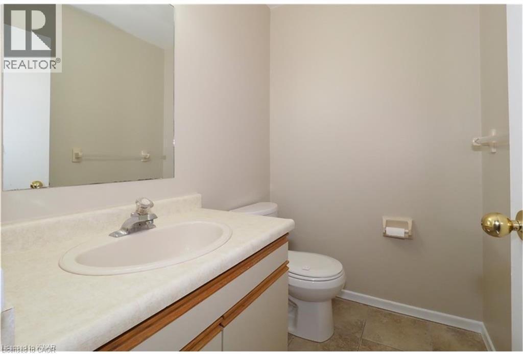 Half bathroom featuring vanity and toilet - 455 Kingscourt Drive Unit# 3, Waterloo, ON - Indoor Photo Showing Bathroom