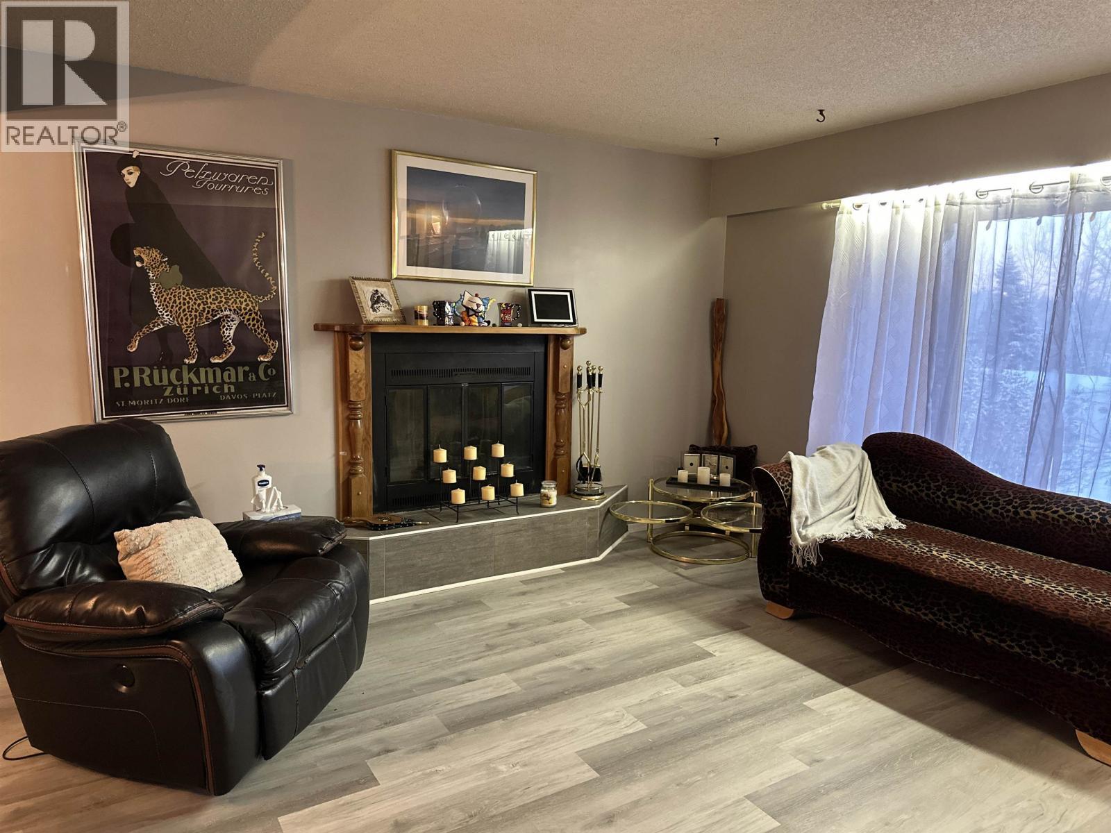 5735 Gairdner Crescent, Fort Nelson, BC - Indoor Photo Showing Living Room With Fireplace