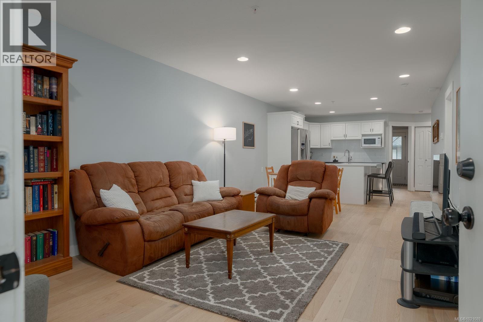 Living area featuring recessed lighting and light wood-style floors - 101 211 Victoria Rd, Nanaimo, BC