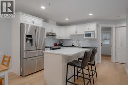 Kitchen with stainless steel appliances and a breakfast bar area -