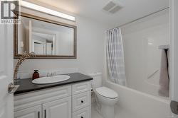 Bathroom featuring vanity, shower / bath combination with curtain, and tile patterned flooring -