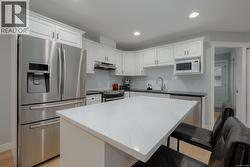 Kitchen with stainless steel appliances and a breakfast bar area -