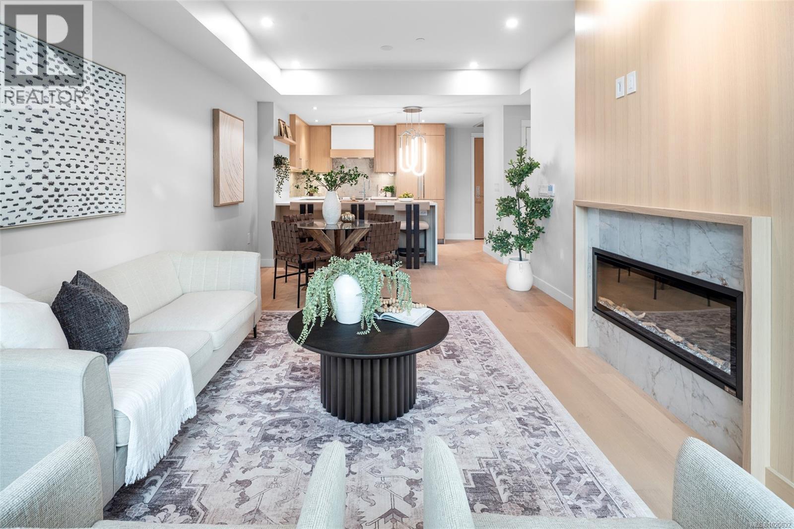 204 5229 Cordova Bay Rd, Saanich, BC - Indoor Photo Showing Living Room With Fireplace