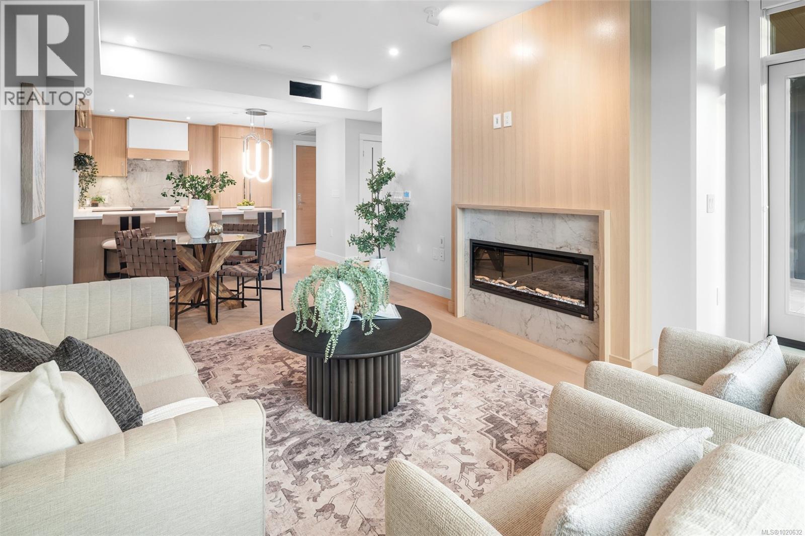 204 5229 Cordova Bay Rd, Saanich, BC - Indoor Photo Showing Living Room With Fireplace
