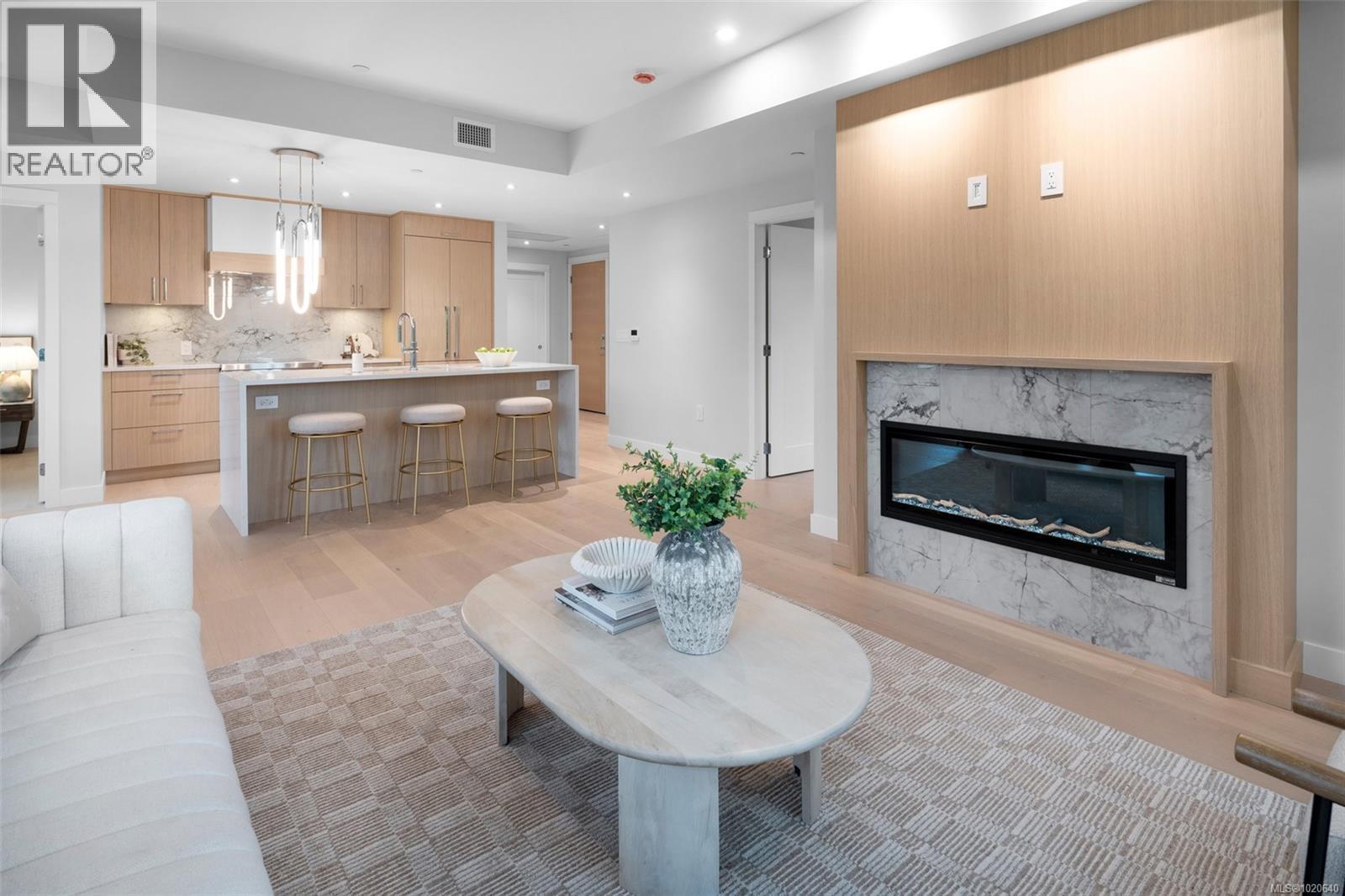 303 5229 Cordova Bay Rd, Saanich, BC - Indoor Photo Showing Living Room With Fireplace