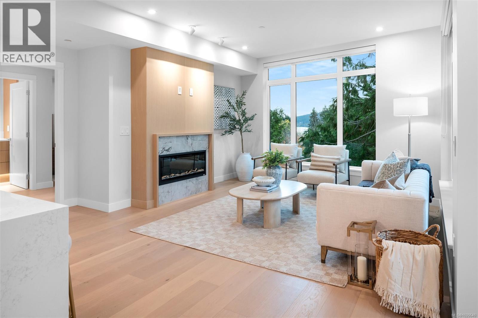 303 5229 Cordova Bay Rd, Saanich, BC - Indoor Photo Showing Living Room With Fireplace