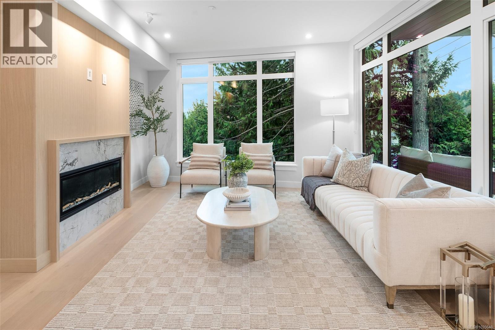 303 5229 Cordova Bay Rd, Saanich, BC - Indoor Photo Showing Living Room With Fireplace