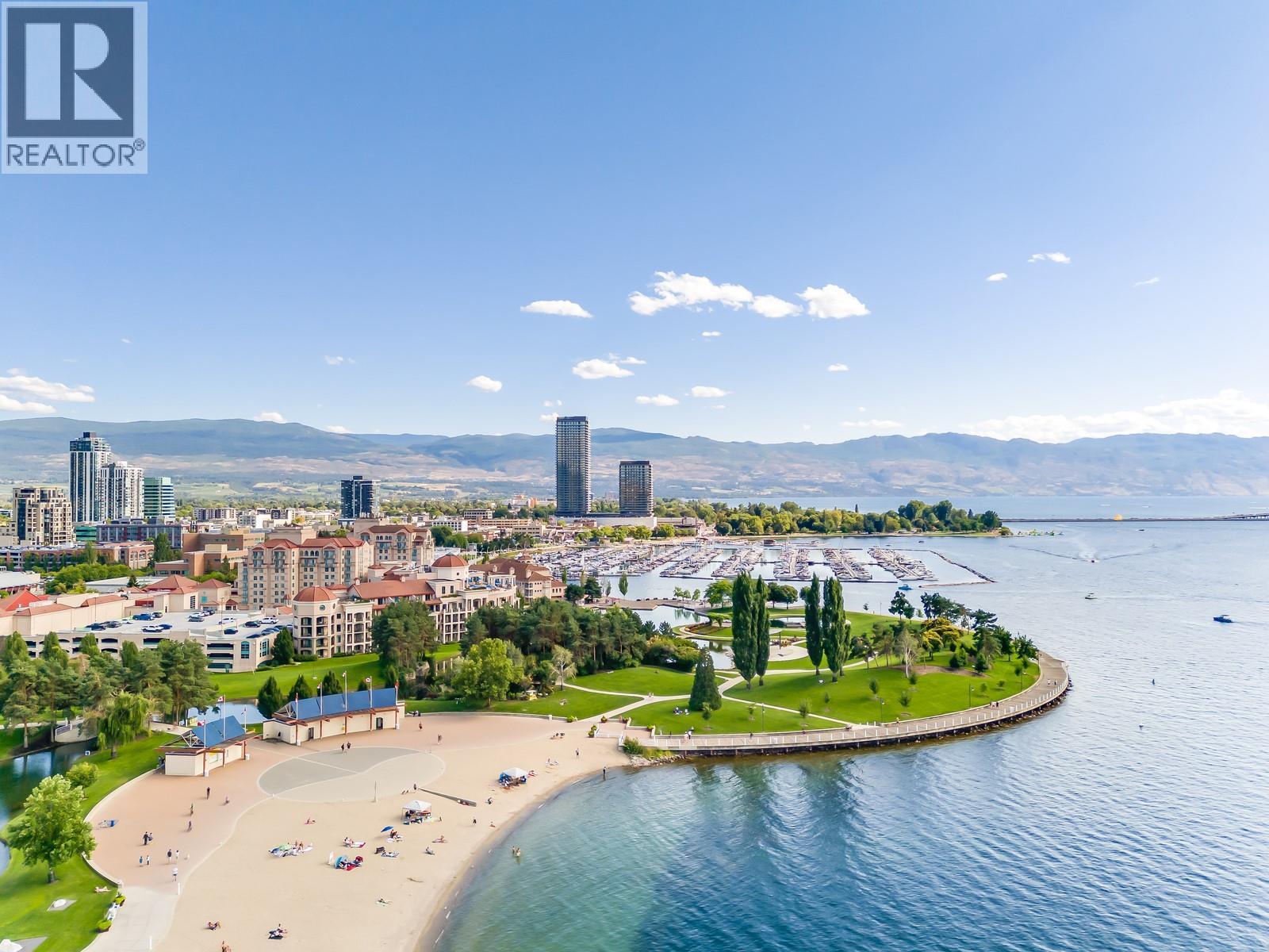 Steps To Tugboat Bay Beach And The Kelowna Waterfront. - 1128 Sunset Drive Unit# 803, Kelowna, BC - Outdoor With Body Of Water With View