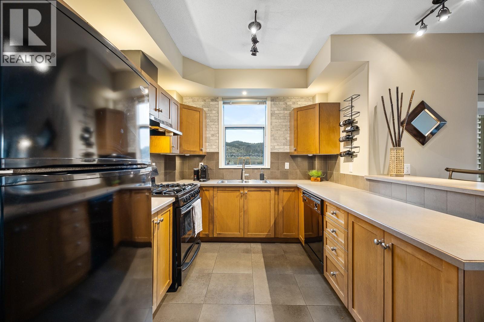 Views of Knox Mountain from your kitchen! - 1128 Sunset Drive Unit# 803, Kelowna, BC - Indoor Photo Showing Kitchen With Double Sink