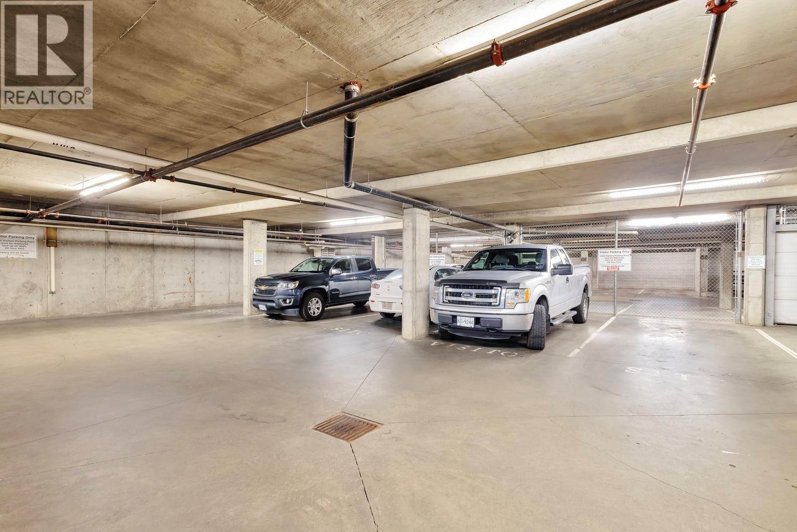 Secure Visitor Parking-- Access From 1st Level - 1128 Sunset Drive Unit# 803, Kelowna, BC - Indoor Photo Showing Garage