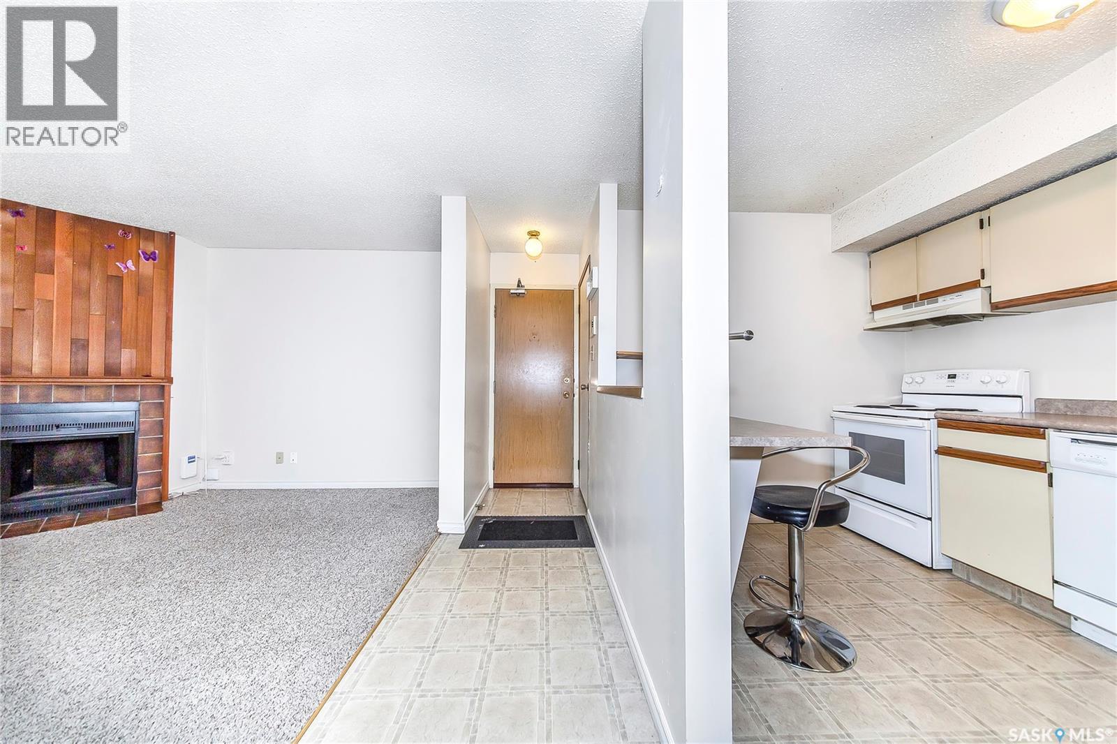103 205 Kingsmere Boulevard, Saskatoon, SK - Indoor Photo Showing Kitchen With Fireplace