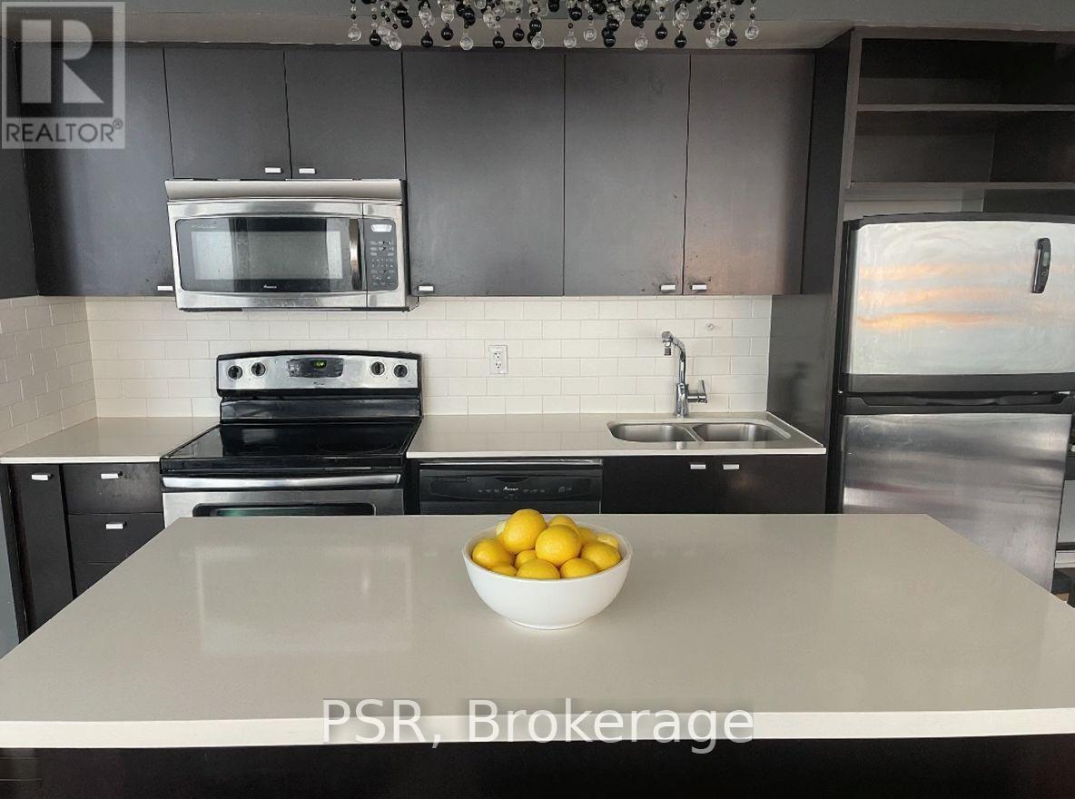Sleek Kitchen with Modern Finishes - 2104 - 103 The Queens Way, Toronto, ON - Indoor Photo Showing Kitchen With Stainless Steel Kitchen With Double Sink With Upgraded Kitchen
