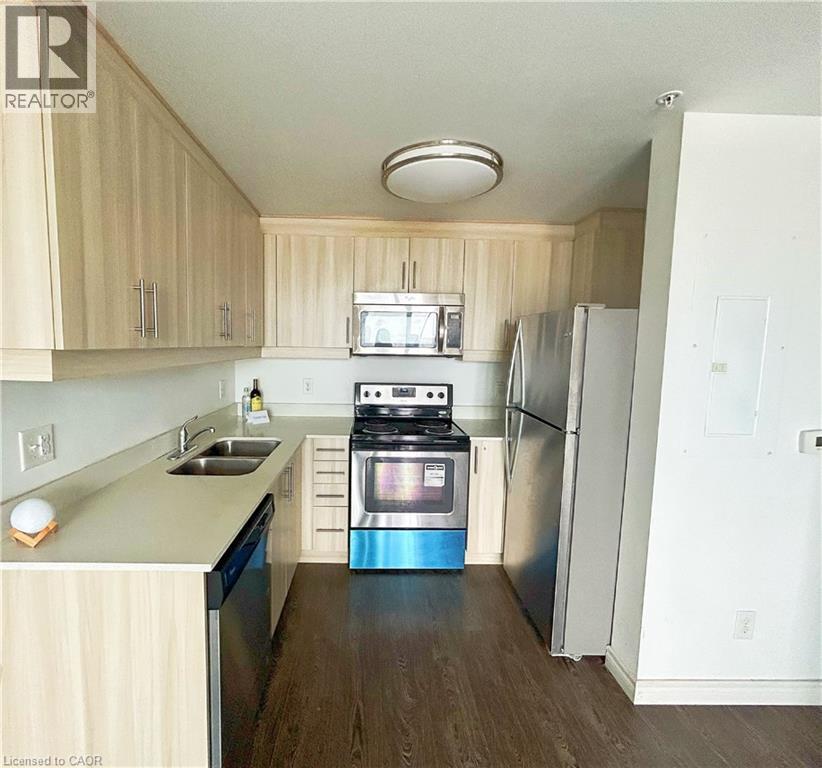 Kitchen with light brown cabinets, appliances with stainless steel finishes, dark wood-style flooring, and electric panel - 158 King Street N Unit# 1504, Waterloo, ON - Indoor Photo Showing Kitchen With Double Sink