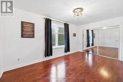 Primary Bedroom Boasts Hardwood Flooring -