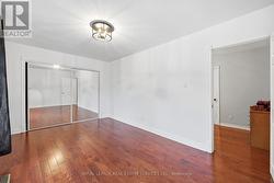 Primary Bedroom Boasts Hardwood Flooring -