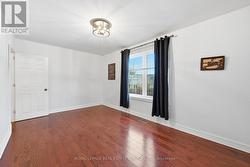 Primary Bedroom Boasts Hardwood Flooring -
