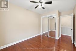 Second Bedroom w/Ceiling Fan and Hardwood Flooring -