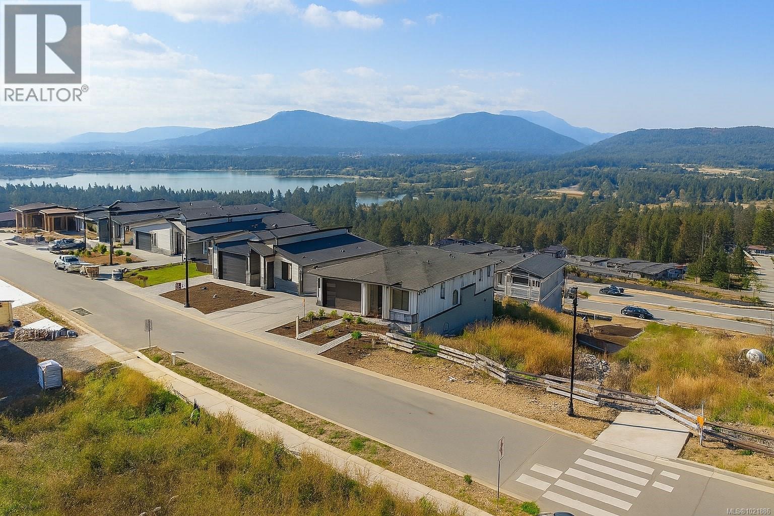 Aerial perspective of suburban area with a water and mountain view - 3195 Woodrush Dr, Duncan, BC - Outdoor With View