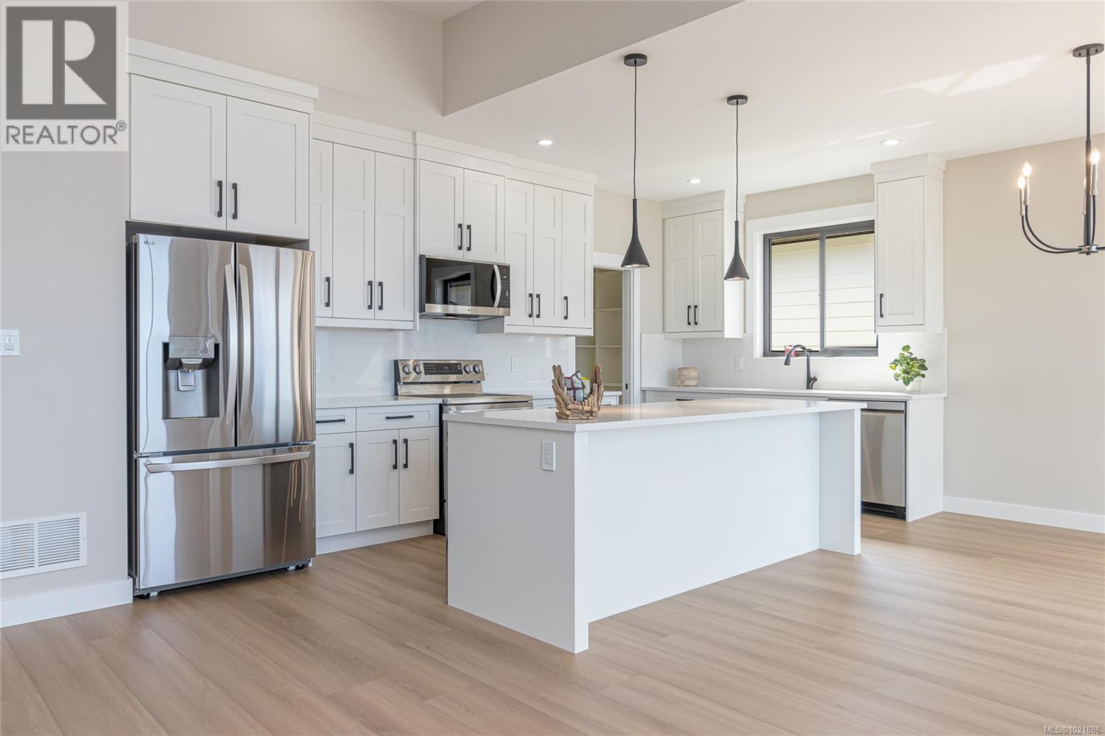 Kitchen with stainless steel appliances, a center island, white cabinets, and recessed lighting - 3195 Woodrush Dr, Duncan, BC - Indoor Photo Showing Kitchen With Upgraded Kitchen