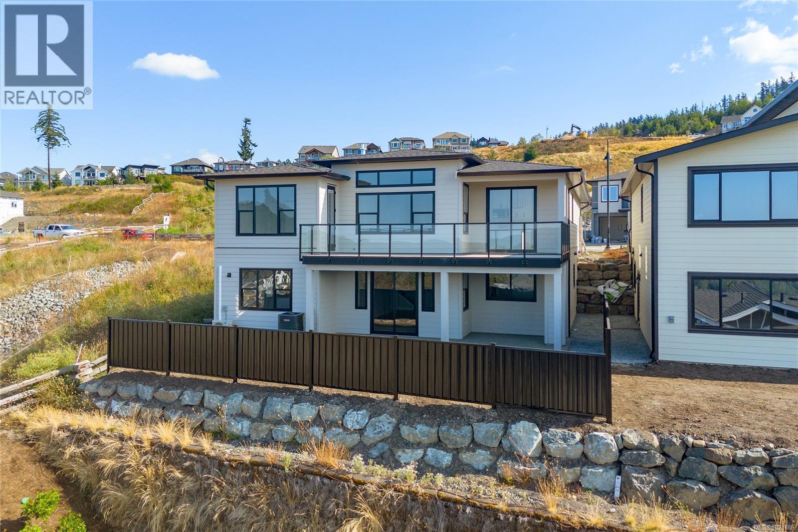 Back of property with a patio and a balcony - 3195 Woodrush Dr, Duncan, BC - Outdoor