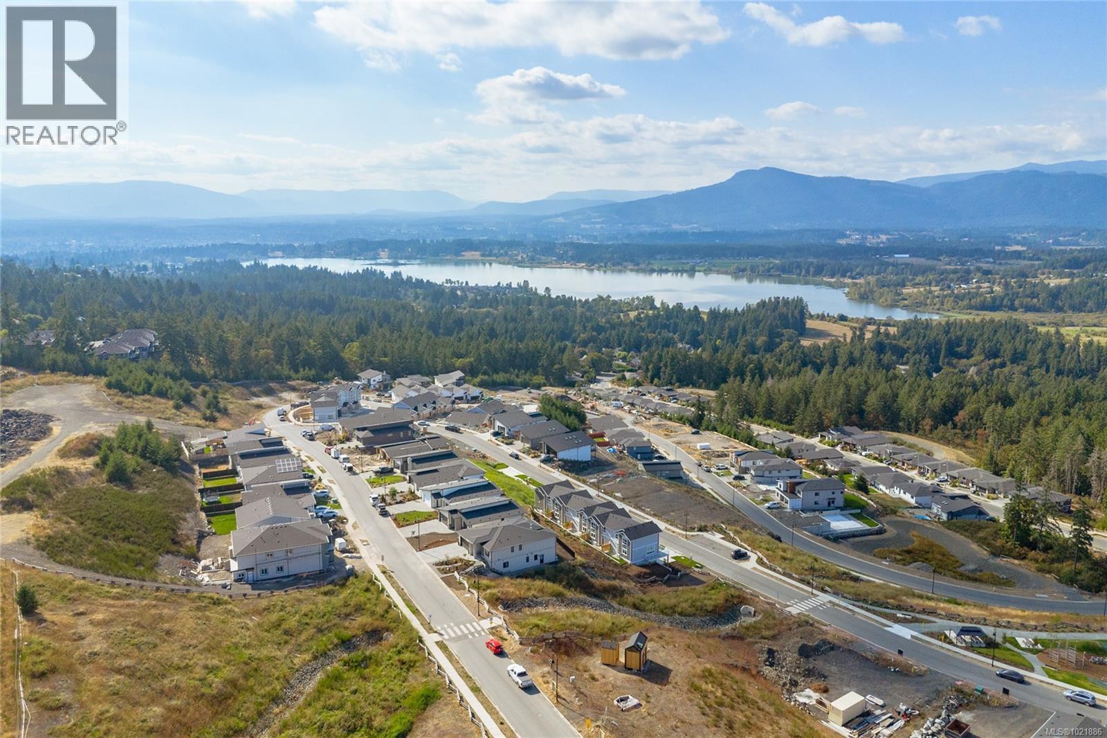 Aerial overview of property's location with a water and mountain view and nearby suburban area - 3195 Woodrush Dr, Duncan, BC - Outdoor With View