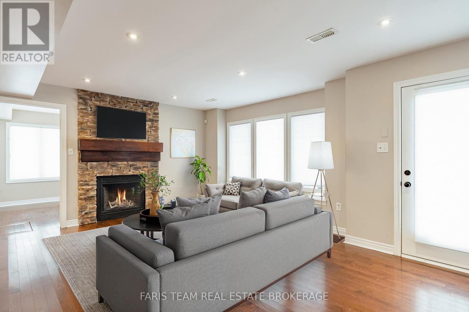 Virtually Staged - 44 Marina Village Drive, Georgian Bay, ON - Indoor Photo Showing Living Room With Fireplace