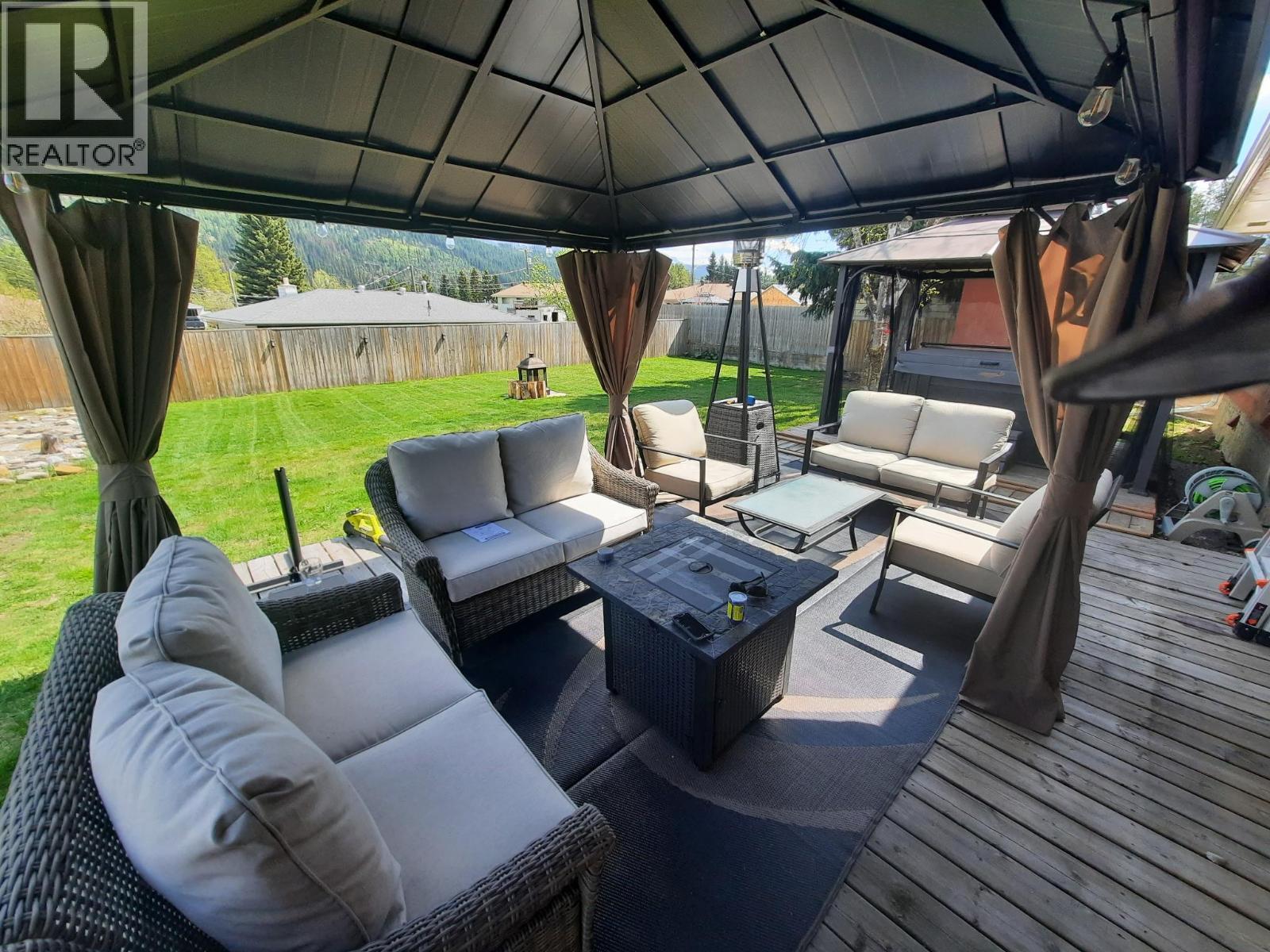 Photo of backyard from summer - 176 Cambourne Crescent, Elkford, BC - Outdoor With Deck Patio Veranda