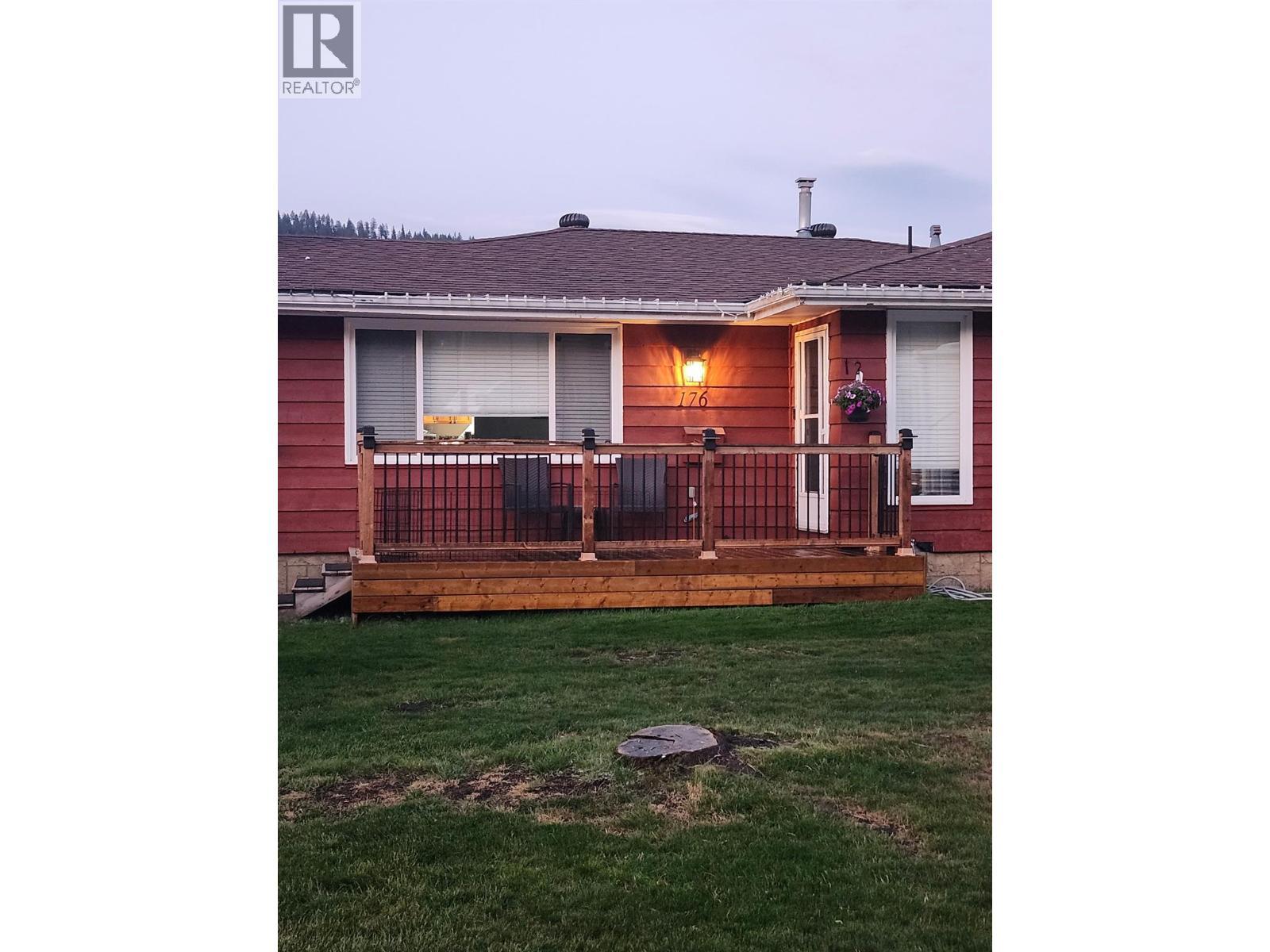 Photo of front of house from summer - 176 Cambourne Crescent, Elkford, BC - Outdoor With Deck Patio Veranda