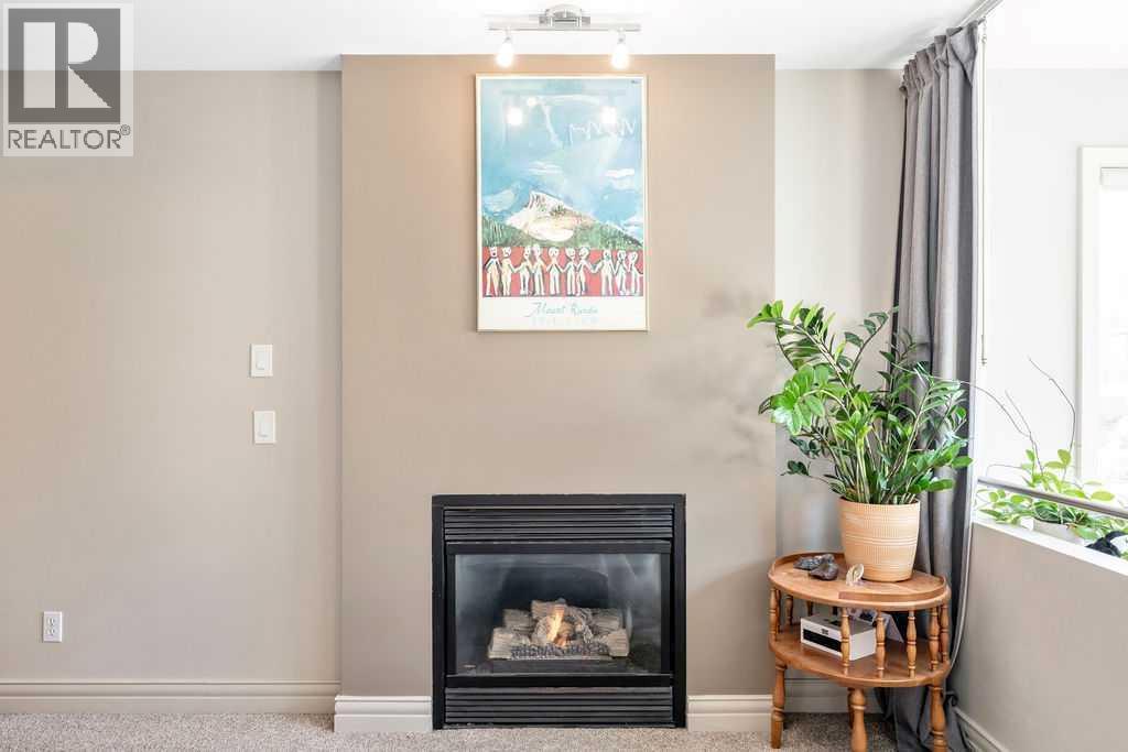 2, 52 6 Street Ne, Calgary, AB - Indoor Photo Showing Living Room With Fireplace