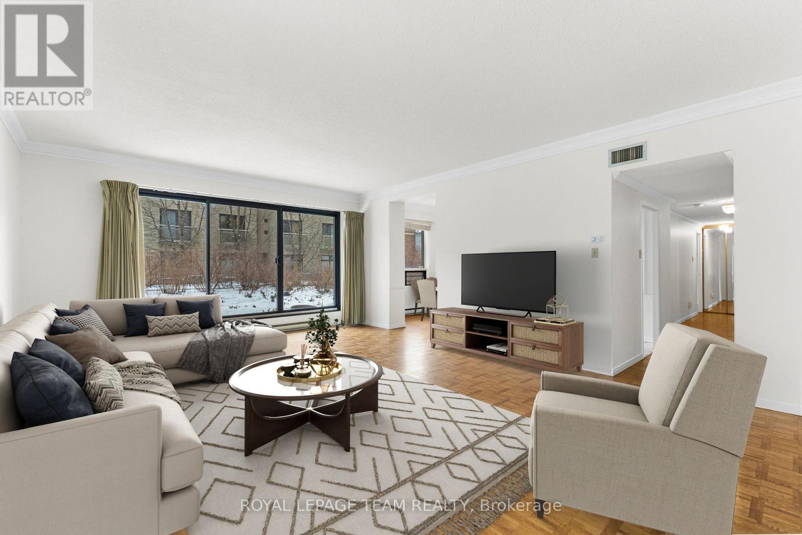 Virtually staged living room - 101 - 20 The Driveway Drive, Ottawa, ON - Indoor Photo Showing Living Room