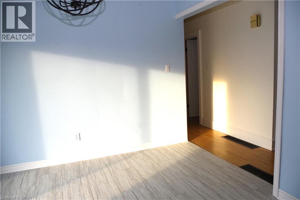 Unfurnished room featuring baseboards and wood finished floors - 425 Wellington Street E, Mount Forest, ON - Indoor Photo Showing Other Room