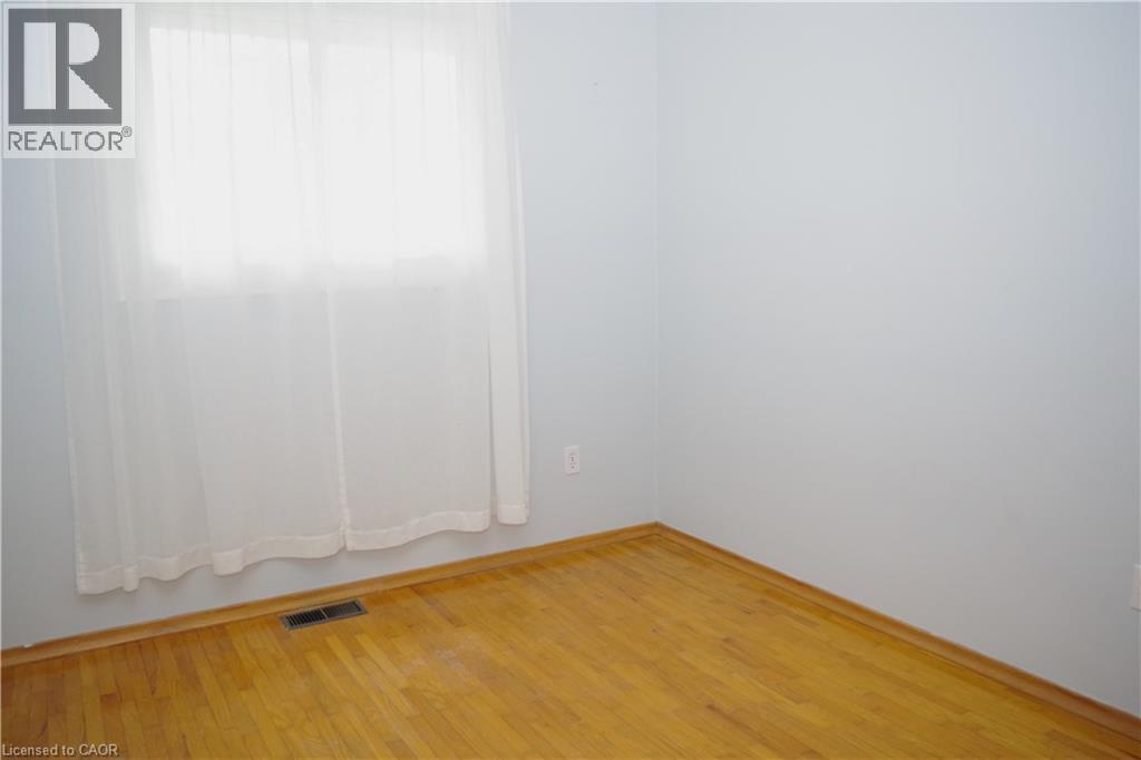 Unfurnished room with wood finished floors - 425 Wellington Street E, Mount Forest, ON - Indoor Photo Showing Other Room