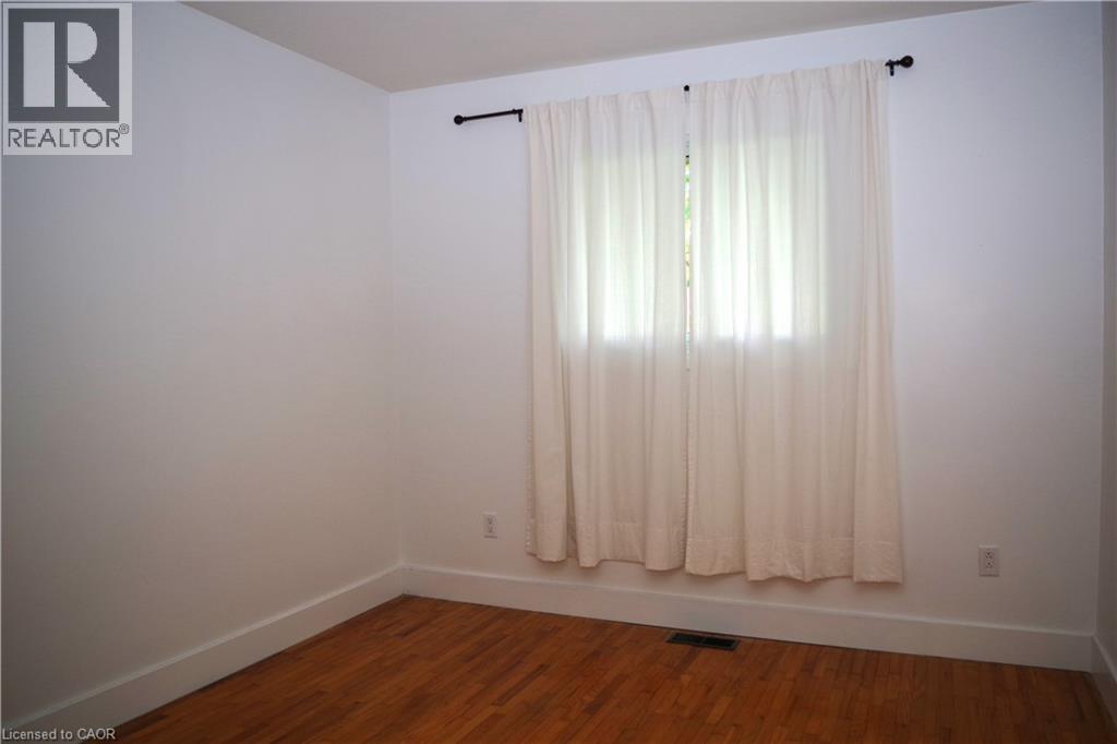 Spare room featuring baseboards and dark wood-type flooring - 425 Wellington Street E, Mount Forest, ON - Indoor Photo Showing Other Room